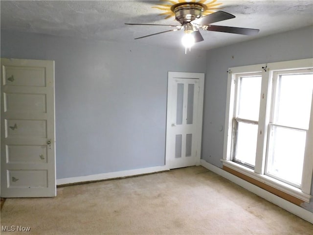 carpeted empty room featuring a textured ceiling