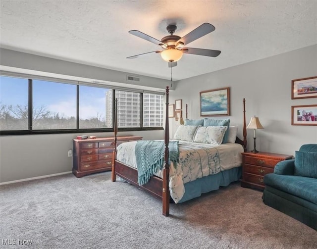 bedroom with ceiling fan, a textured ceiling, and carpet