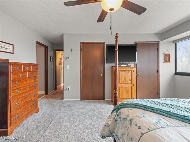 bedroom featuring light colored carpet and ceiling fan