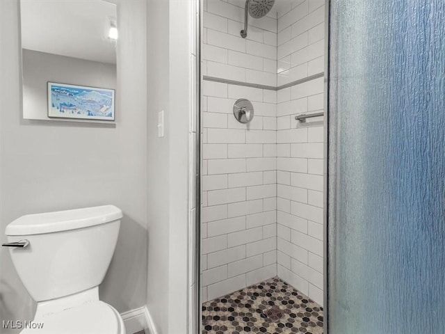 bathroom with an enclosed shower and toilet