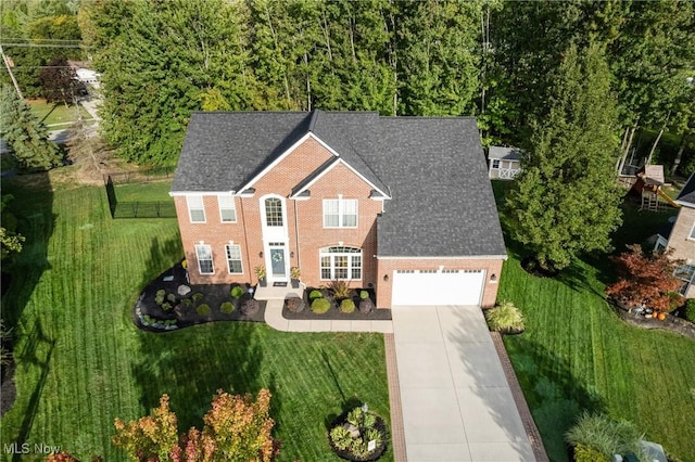 view of front facade featuring a garage and a front lawn