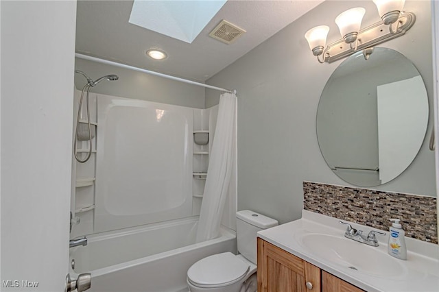 full bathroom with a skylight, decorative backsplash, vanity, toilet, and shower / bathtub combination with curtain