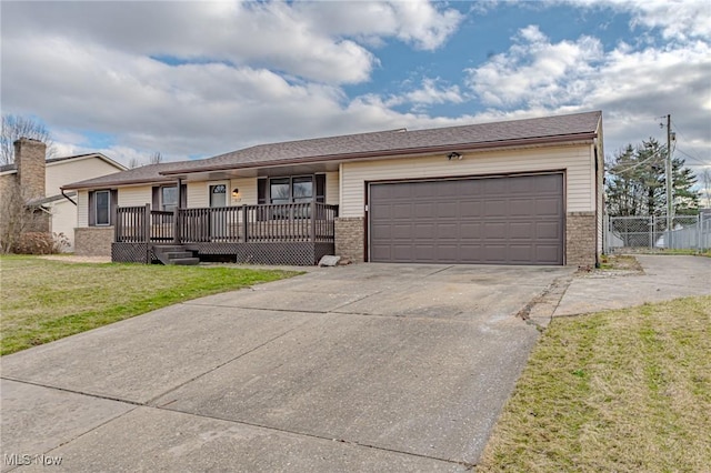 ranch-style house with a garage and a front lawn