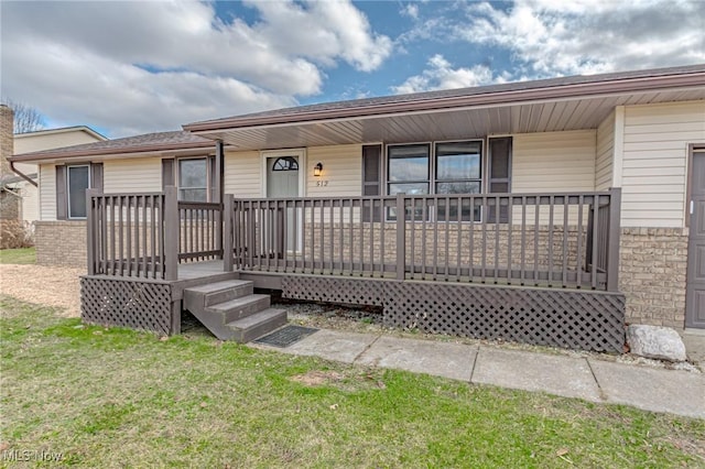 single story home featuring a front yard and covered porch