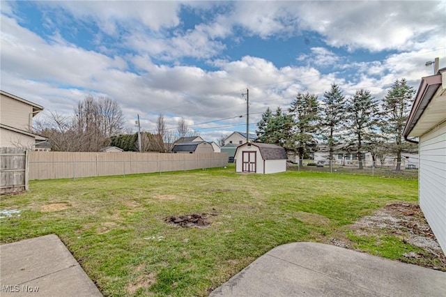 view of yard featuring a storage unit and a patio