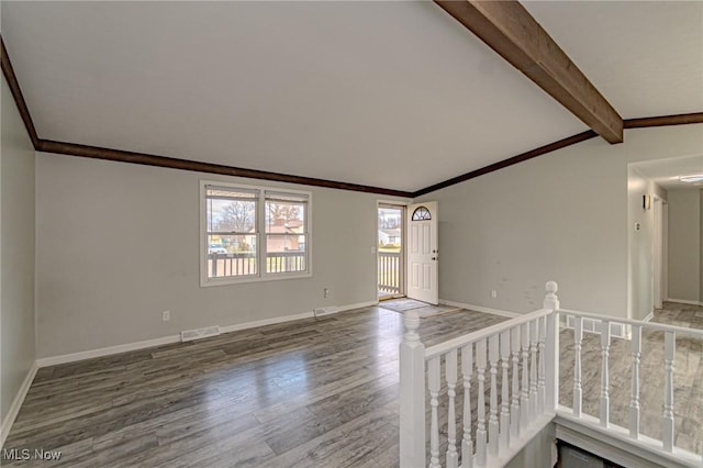 unfurnished room featuring ornamental molding, wood-type flooring, and lofted ceiling with beams