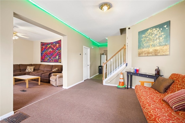 living room with ceiling fan and carpet