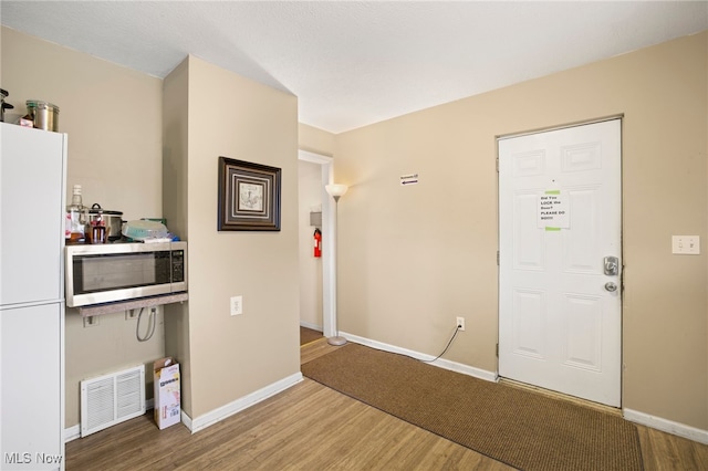 foyer entrance with hardwood / wood-style floors