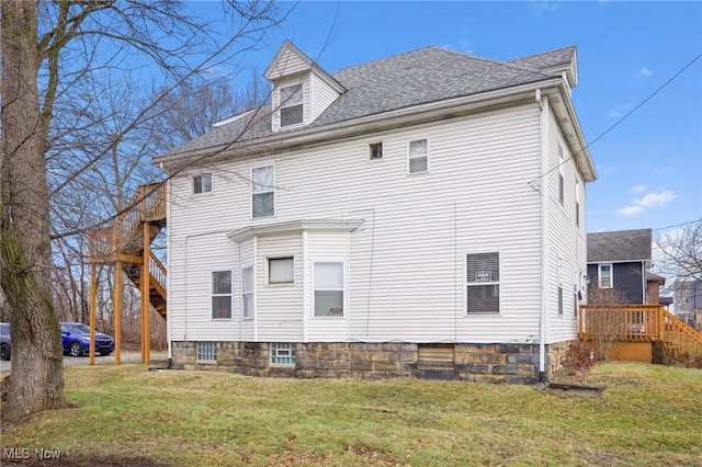 back of house featuring a yard and a deck