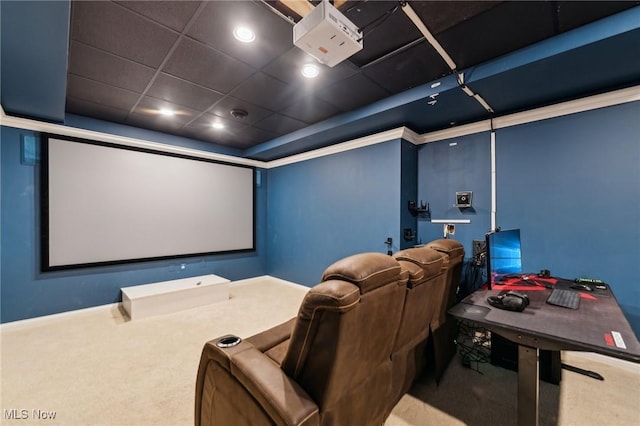 carpeted cinema room with a drop ceiling