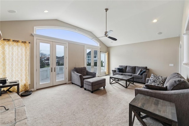 carpeted living room with lofted ceiling, french doors, and ceiling fan