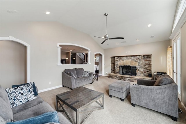 carpeted living room featuring ceiling fan, lofted ceiling, and a fireplace