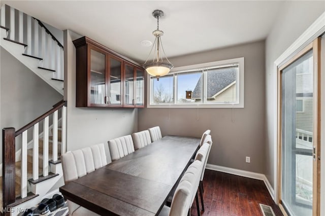 dining space with dark wood-type flooring