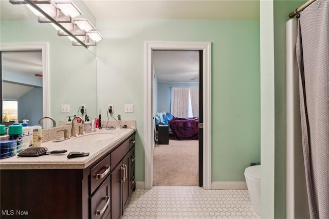 bathroom featuring vanity and toilet