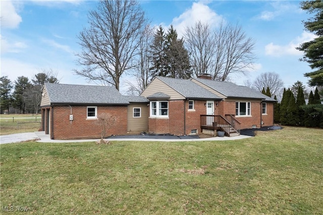 rear view of property with a yard