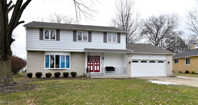 view of front of home featuring a garage, a front lawn, and a porch