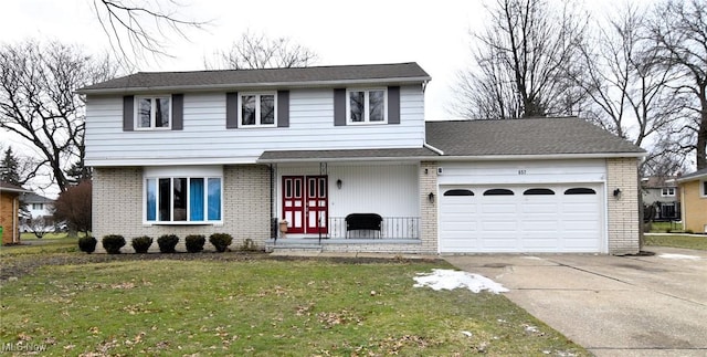 front of property with a garage and a front lawn