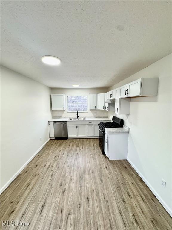 kitchen featuring white cabinetry, dishwasher, black gas stove, and light wood-type flooring