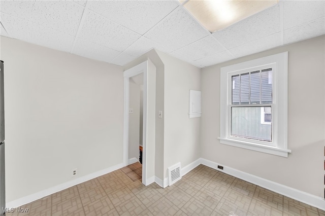 unfurnished room with a paneled ceiling