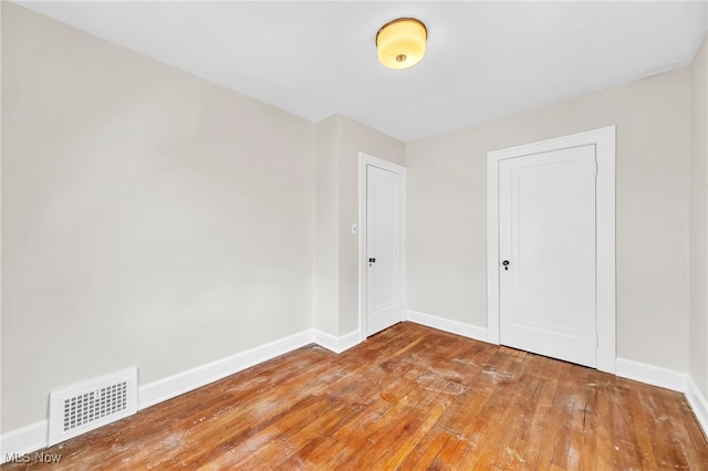 spare room featuring wood-type flooring