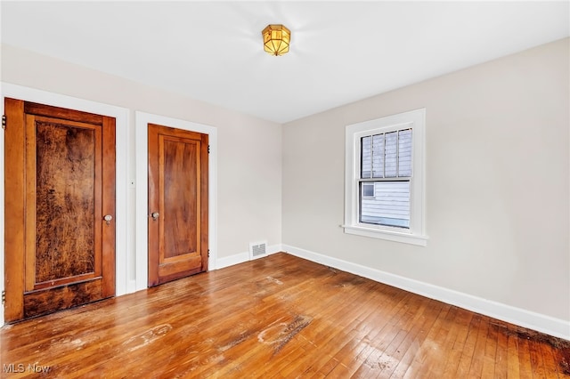 unfurnished bedroom with light wood-type flooring