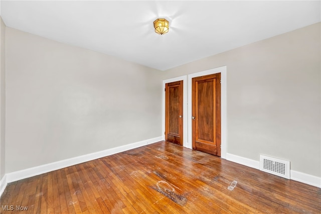 spare room with hardwood / wood-style flooring