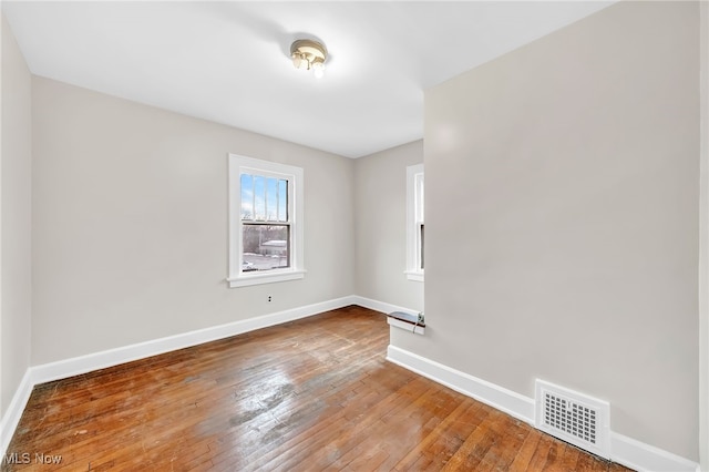 spare room with hardwood / wood-style floors