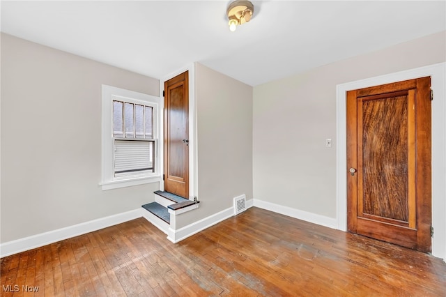 unfurnished room with wood-type flooring