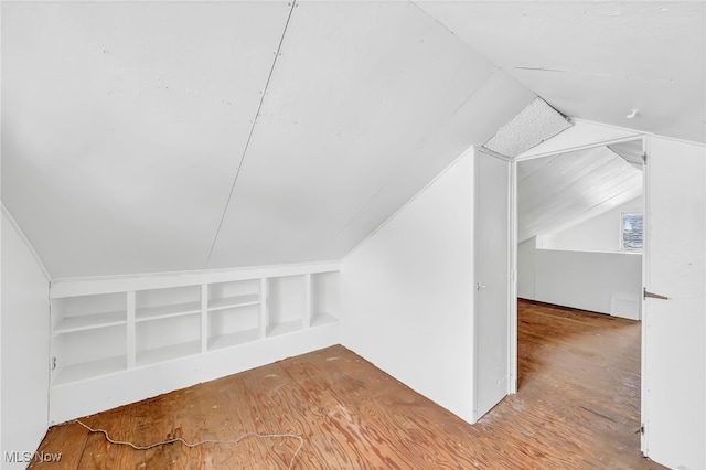 bonus room featuring lofted ceiling and wood-type flooring