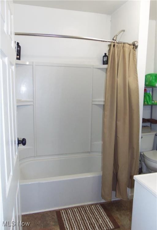 bathroom featuring shower / bath combination with curtain and toilet