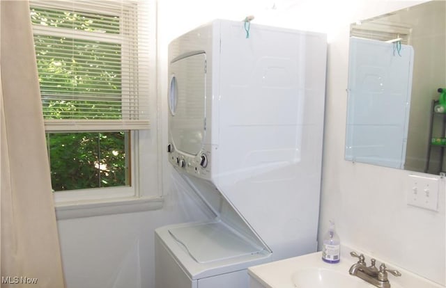 bathroom with vanity and stacked washer and clothes dryer