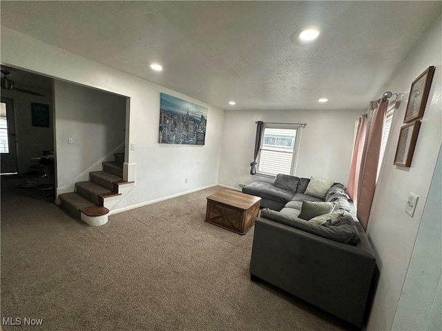 living room featuring carpet flooring and a textured ceiling