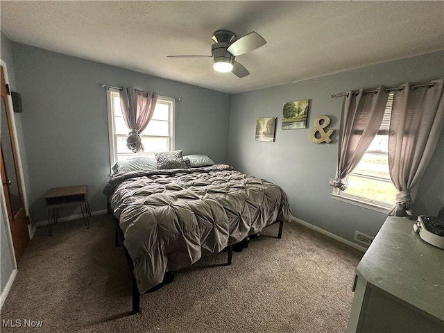 bedroom featuring ceiling fan, carpet flooring, and multiple windows