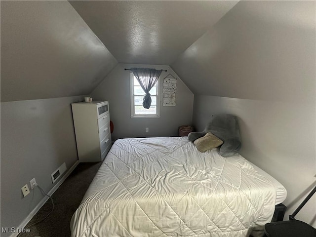 carpeted bedroom featuring vaulted ceiling