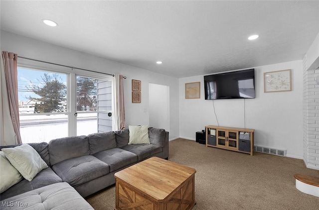 carpeted living area with baseboards, visible vents, and recessed lighting