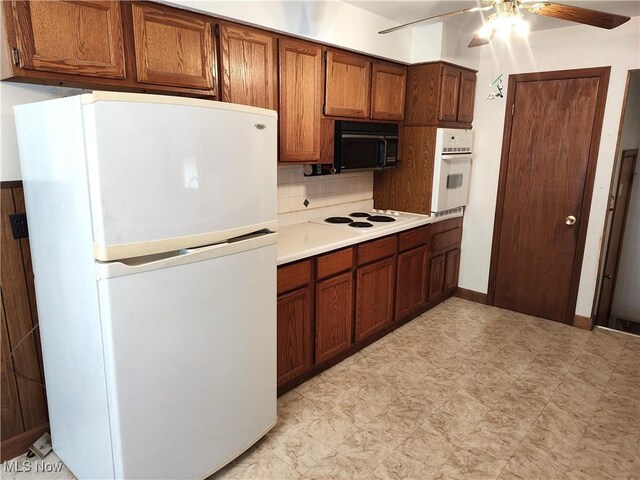 kitchen with white appliances, decorative backsplash, and ceiling fan