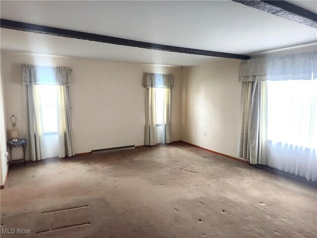 unfurnished room with beamed ceiling