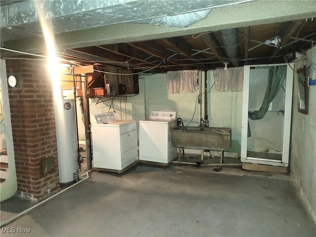 basement with separate washer and dryer, sink, and water heater