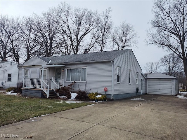 view of front of property with a garage, an outdoor structure, and a front yard