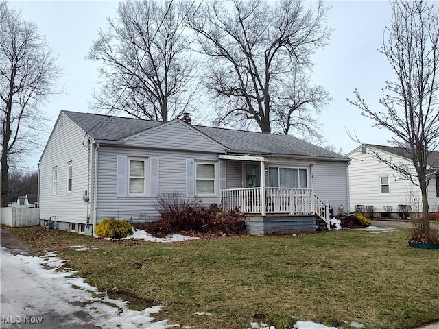 view of front of home featuring a front yard and covered porch