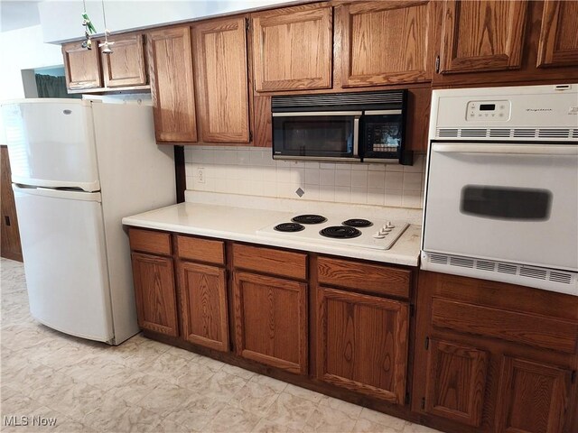 kitchen featuring white appliances and decorative backsplash