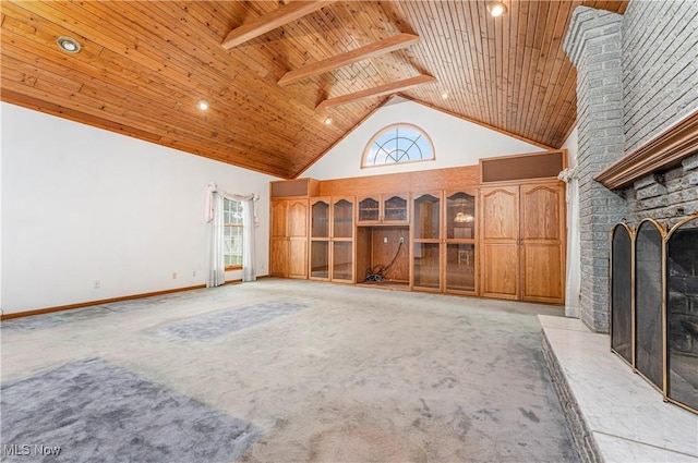 unfurnished living room with wood ceiling, high vaulted ceiling, a fireplace, light carpet, and beamed ceiling