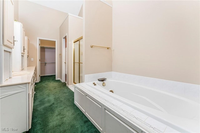 bathroom with vanity and tiled bath