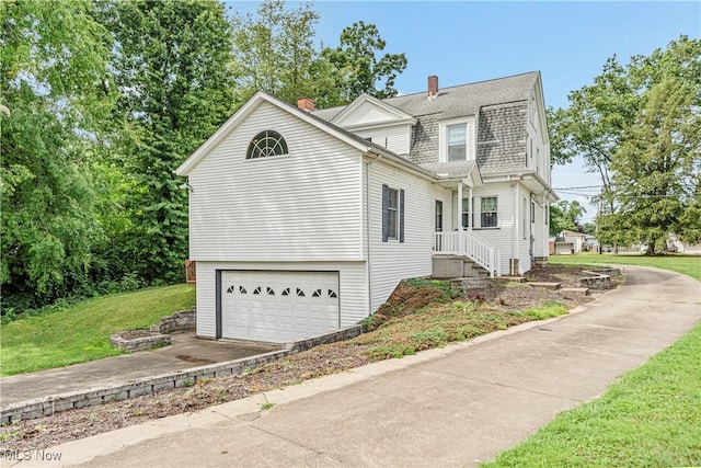 front facade with a garage and a front lawn