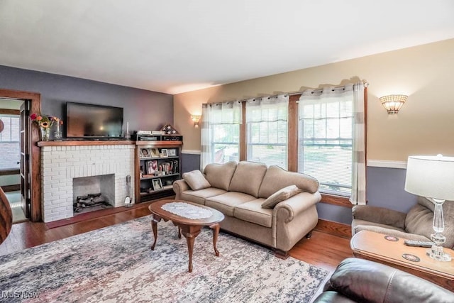 living room featuring hardwood / wood-style flooring and a fireplace