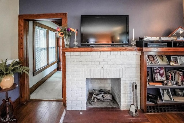 room details with wood-type flooring and a brick fireplace