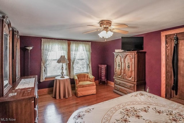 bedroom featuring ceiling fan and wood-type flooring