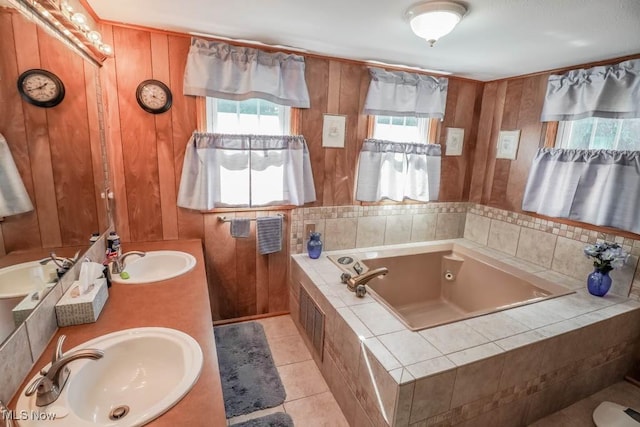 bathroom featuring a wealth of natural light, wood walls, tile patterned floors, and tiled bath