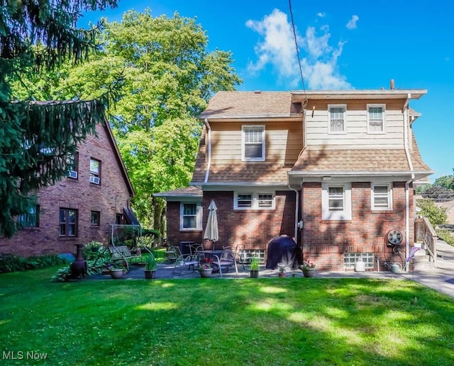 back of house with a yard and a patio