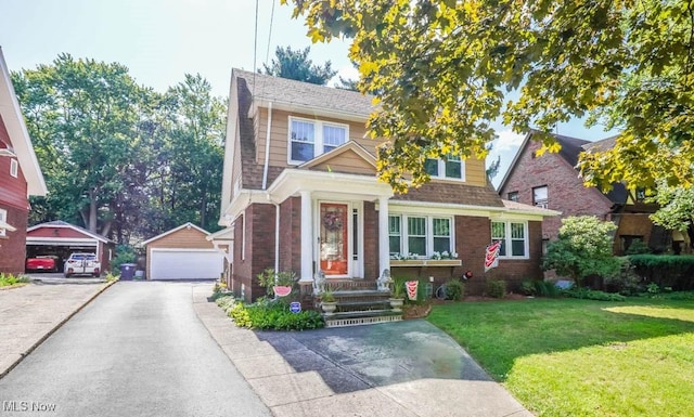 view of front of home featuring a garage, an outdoor structure, and a front yard